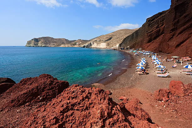 Red Volcanic Beach with on Santorini. Beautiful summer day with clear sky over the Turquoise Water on Santorini, Greece.