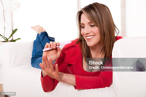 Smiling Female Filing Her Fingernails Stock Photo - Download Image Now - 20-24 Years, 25-29 Years, Adult