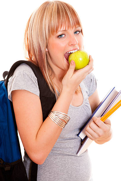 istock Young female student eating a green apple 122904737