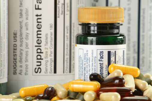 Composition with variety of dietary supplements capsules and containers