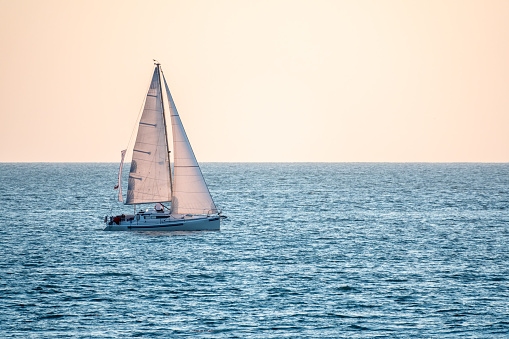 Sailing yacht in the blue calm sea. Yacht in peaceful waters.