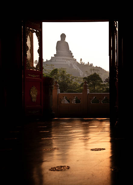 statue of Buddha is a sacred and revered Buddha image located outdoors inside the school for students to pay their respects in the evening blue sky and see the serene atmosphere and white background.