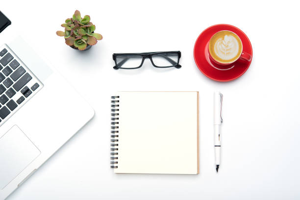 istock Top view with working desk with laptop,cellphone,notebook pencil coffee cup and eyeglasses in the office. 1229369983
