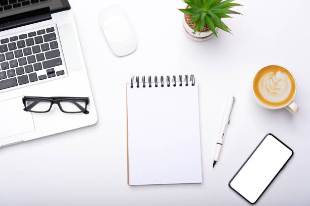 istock Top view with working desk with laptop,cellphone,notebook pencil coffee cup and eyeglasses in the office. 1229370013