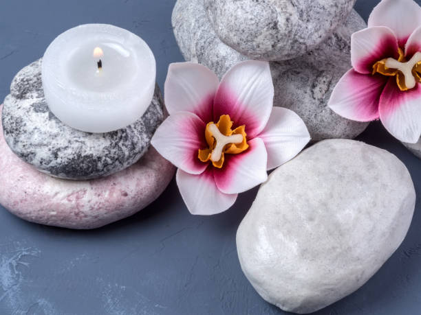 istock Flowers, burning candle and stone for spa. Spa composition 1229380229
