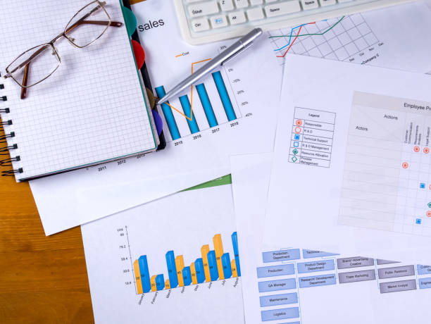 istock Charts, notebook glasses and a ballpoint pen on the desktop 1229392829