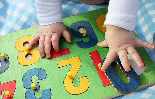 Photo of child playing with a number puzzle