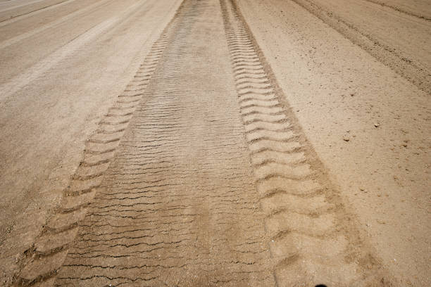 istock Road rollers leave deep tire marks after leveling the dirt road 1229628986