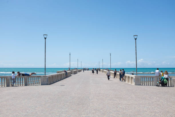 Pier in Ostia, Rome with few people on a sunny day stock photo