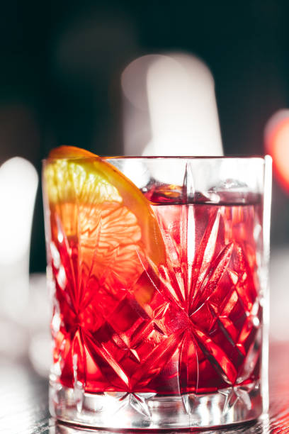 istock Red cocktail in glass isolated on blurred restaurant background. 1229691163