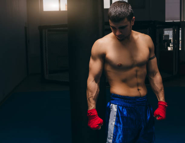 istock Boxer wears red protective bandages on hands, has final training before fight. 1229776956