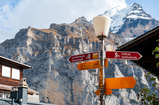 Lauterbrunnen, Switzerland - October 2019: Visitor direction signpost at Murren mountain village situated in the Bernese Highlands in Switzerland