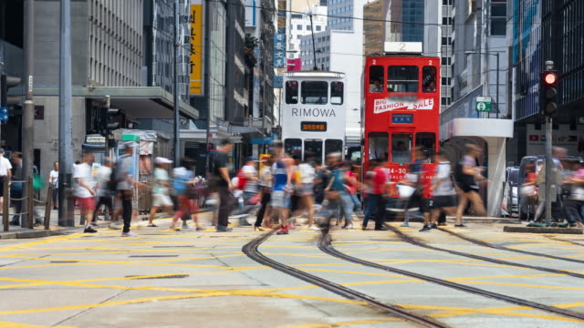 Time lapse crowd of Traffic car and pedestrians crossing road in Hong Kong
