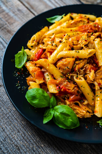 istock Chicken ragout with penne on wooden table 1229787111