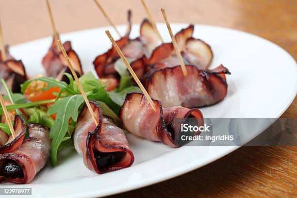 Bacon Bits On A Stick With Prunes Stock Photo - Download Image Now - Dried Plum, Skewer, Appetizer