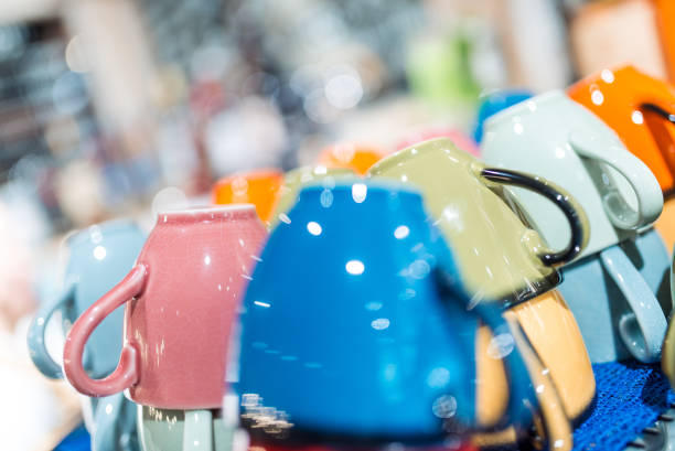 Kitchenware. Set of multi-coloured empty mugs on the shelf-in a restaurant. Different focus