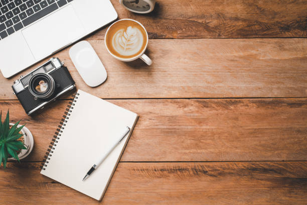 istock top view Office equipment including Laptop, mobile phone, mouse, notebook, coffee cup on the wood floor 1229819606