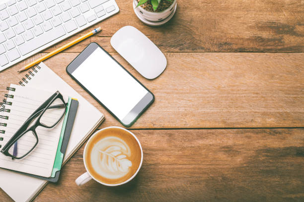 istock top view Office equipment including Laptop, mobile phone, mouse, notebook, coffee cup on the wood floor 1229819941