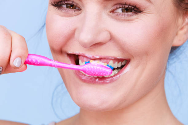 istock Woman brushing cleaning teeth 1229842115