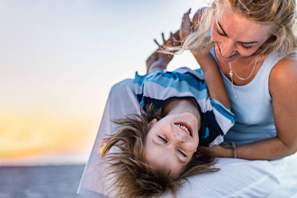 istock Happy little boy having fun with his mother on the beach. 1229853769