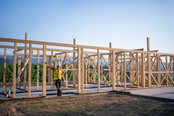 istock Builder Working On Wooden House In Nature. 1229882691