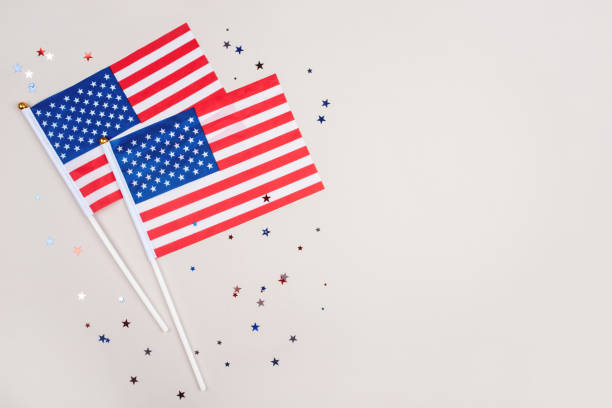 istock Festive background with US flags and confetti. 1229939475