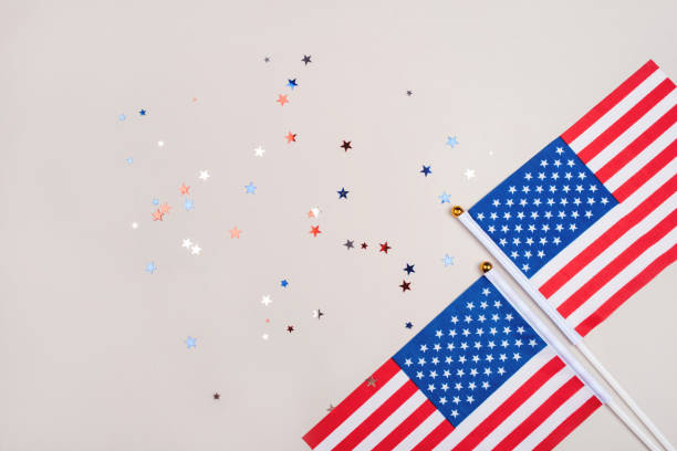 istock Festive background with US flags and confetti. 1229939979