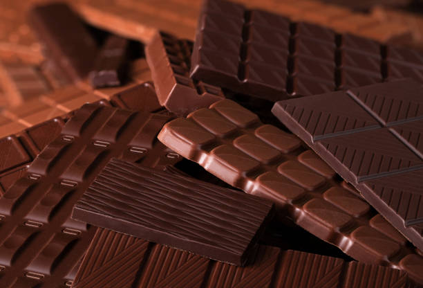 istock heap milk and dark chocolate background. various cocoa bars, top view 1229971848