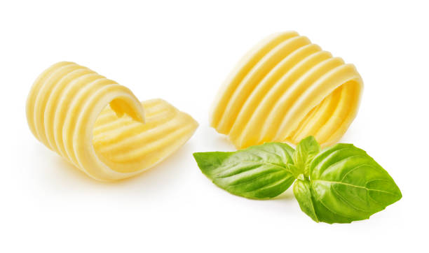 istock Butter curls or butter rolls with basil leaves isolated on white background 1229986595