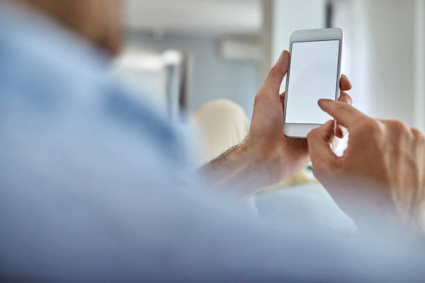 istock Close-up of man using mobile phone. 1229999571