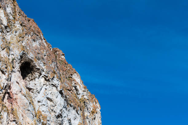 small cave or grotto in mountain cliff, mountaineering and caving in rocks