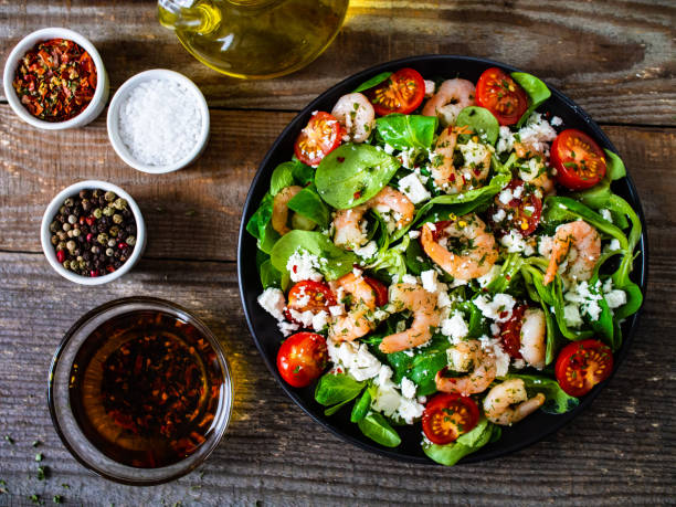 istock Prawns with vegetables on wooden table 1230006246