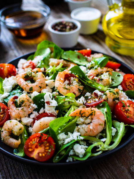 Prawns with vegetables on wooden table