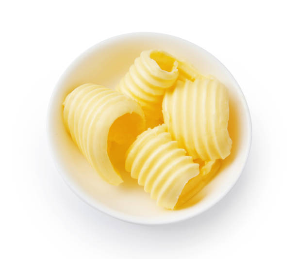 istock Butter curls or butter rolls in white bowl isolated. Top view. 1230012313