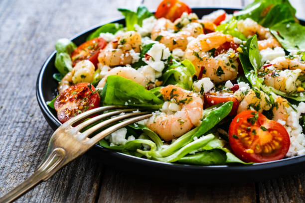 istock Prawns with vegetables on wooden table 1230013121