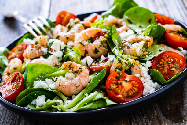 istock Prawns with vegetables on wooden table 1230017125