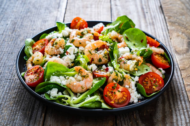 istock Prawns with vegetables on wooden table 1230026498