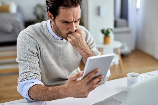 istock Worried entrepreneur reading an e-mail on touchpad while working at home. 1230037753