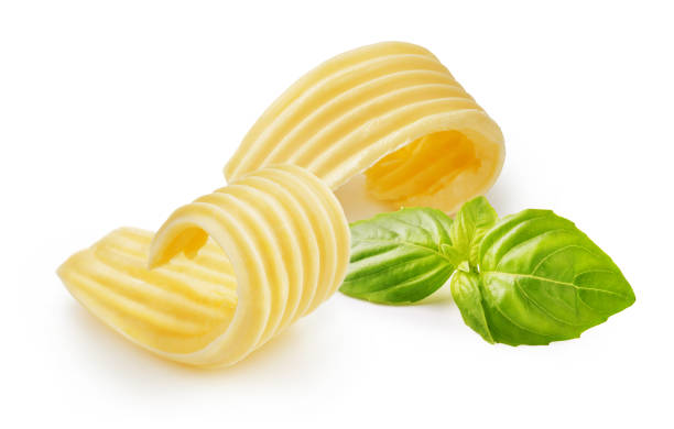 istock Butter curls or butter rolls with basil leaves isolated on white background 1230053291