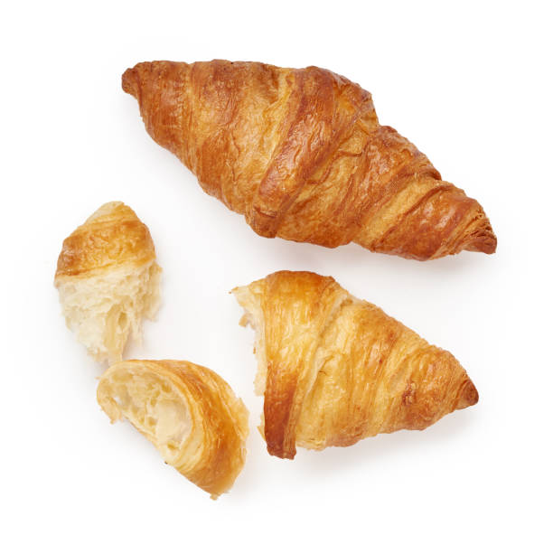 istock Two croissants with crumbs isolated on white background 1230057638