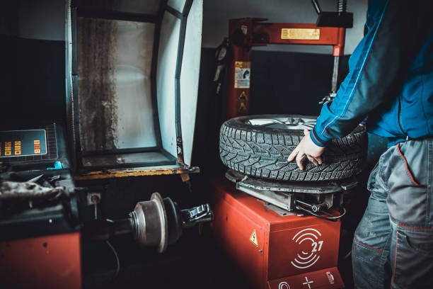 istock Young mechanic replacing a flat tire from wheel 1230083564