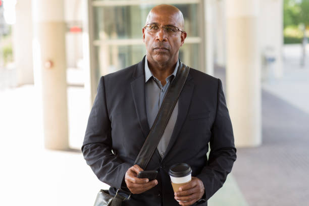 istock African American businessman drinking coffee and texting. 1230100291