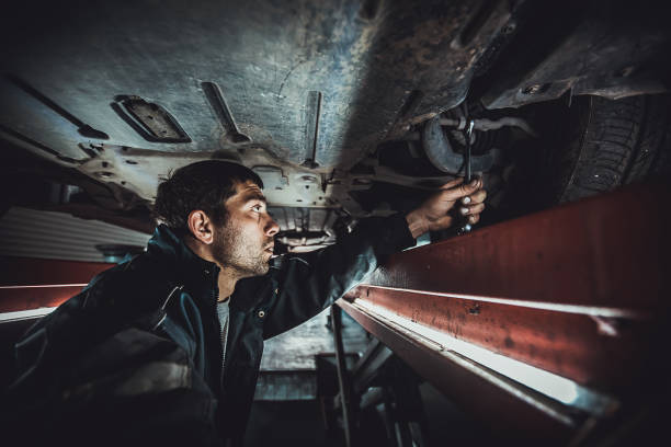 istock Young auto mechanic repairing a car 1230102080