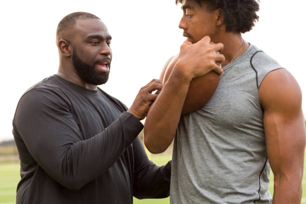 istock American Football coach training a young athlete. 1230110956