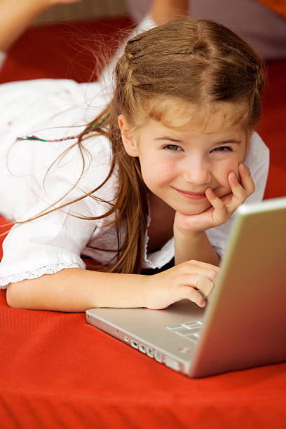 istock Little girl using laptop outdoors 123011791