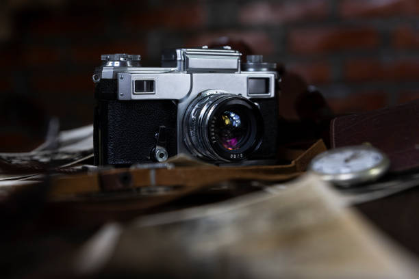 istock Vintage film camera and old photographs on a rustic surface 1230122827