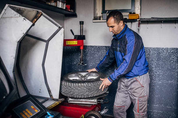 istock One young mechanic replacing a flat tire from wheel 1230126699