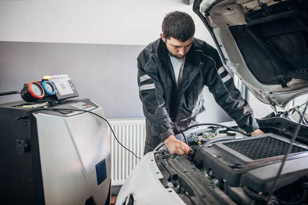istock One young mechanic charging AC in a car 1230130769