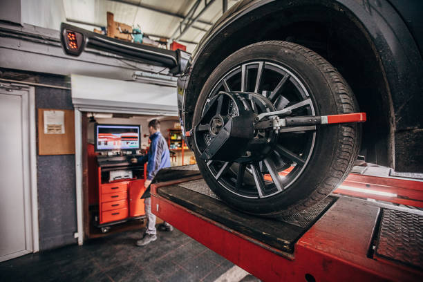istock One auto mehanic balancing wheels in a repair station 1230164757