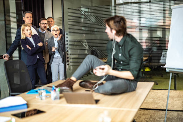 istock Oh my God, what is he doing on the office table? 1230172482